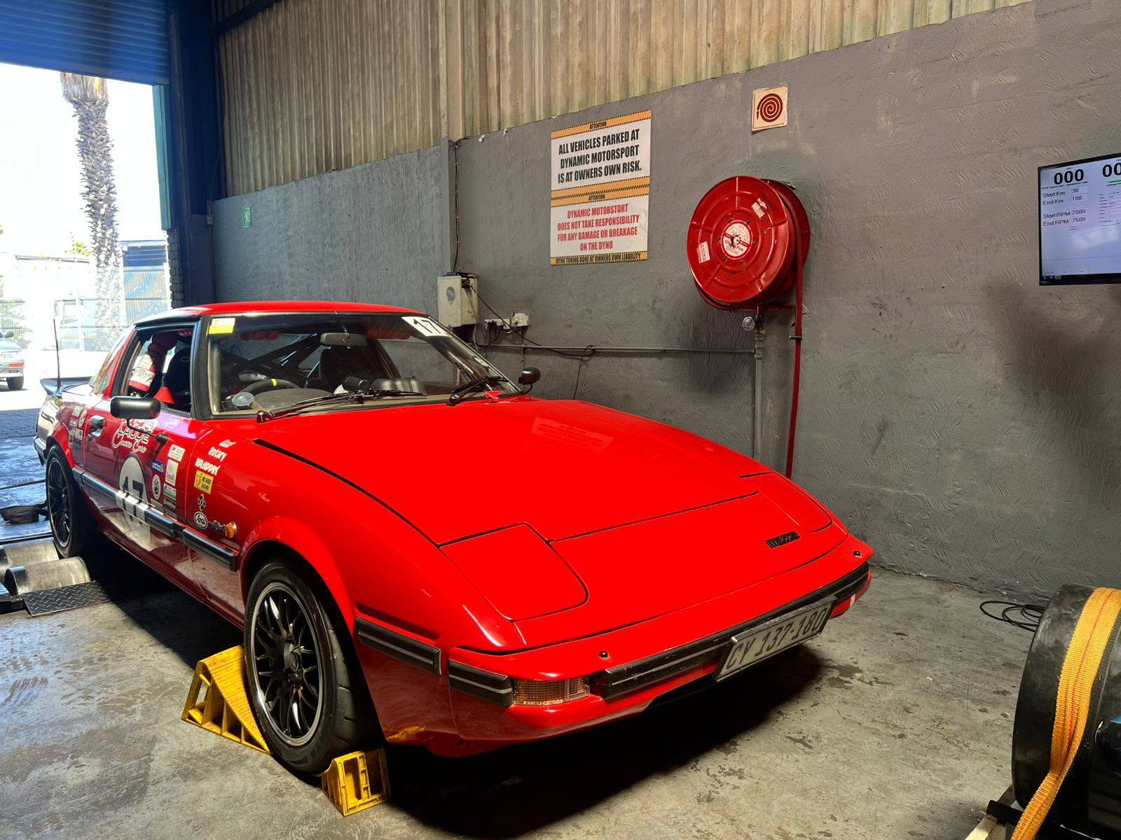 Mazda RX-7 race car strapped down on the Dynamic Motorsport dyno